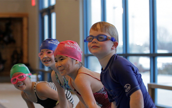 swimmers on edge of pool