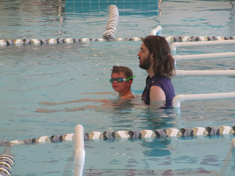 swim teach and student doing back float