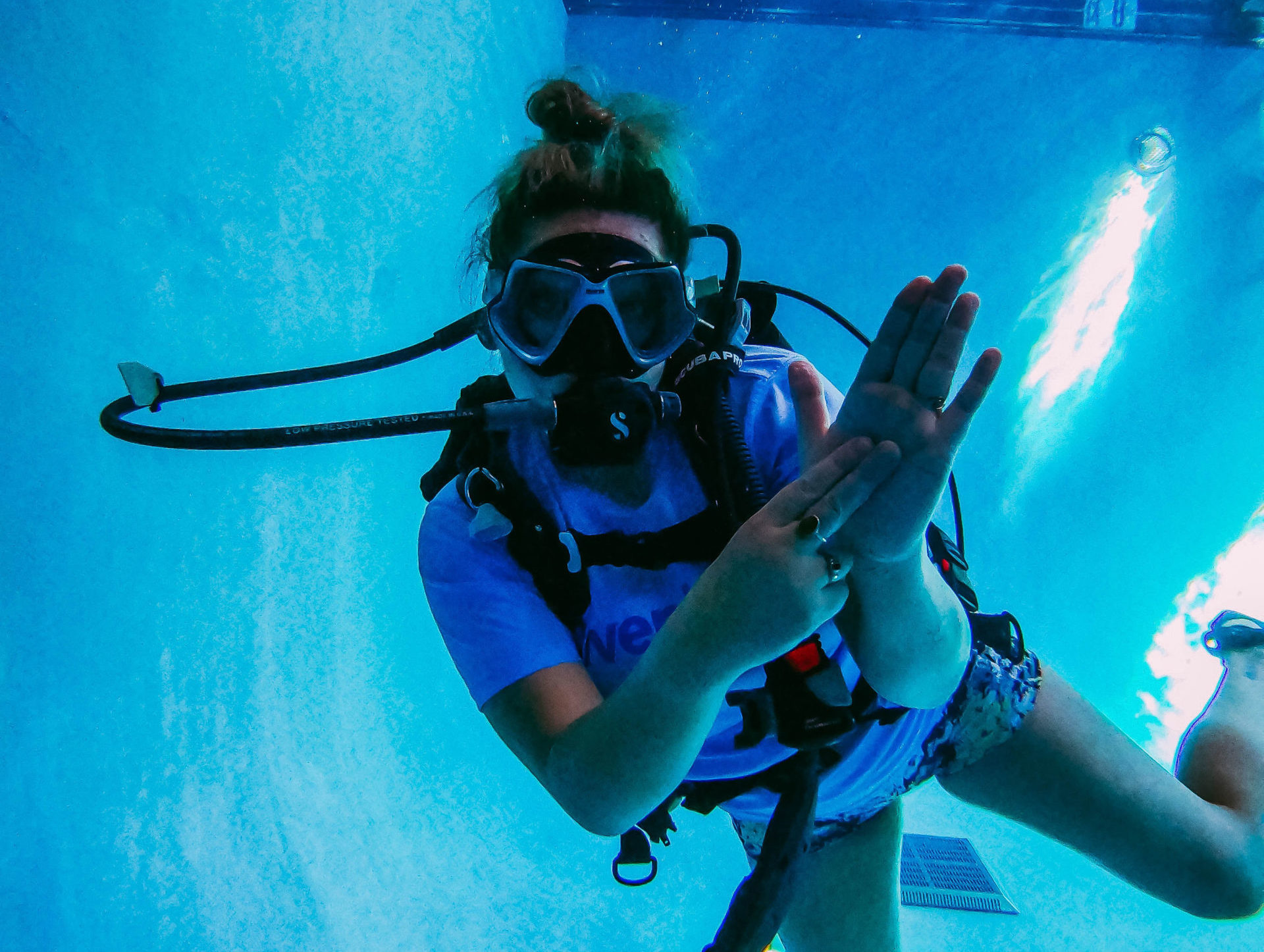 three divers in pool