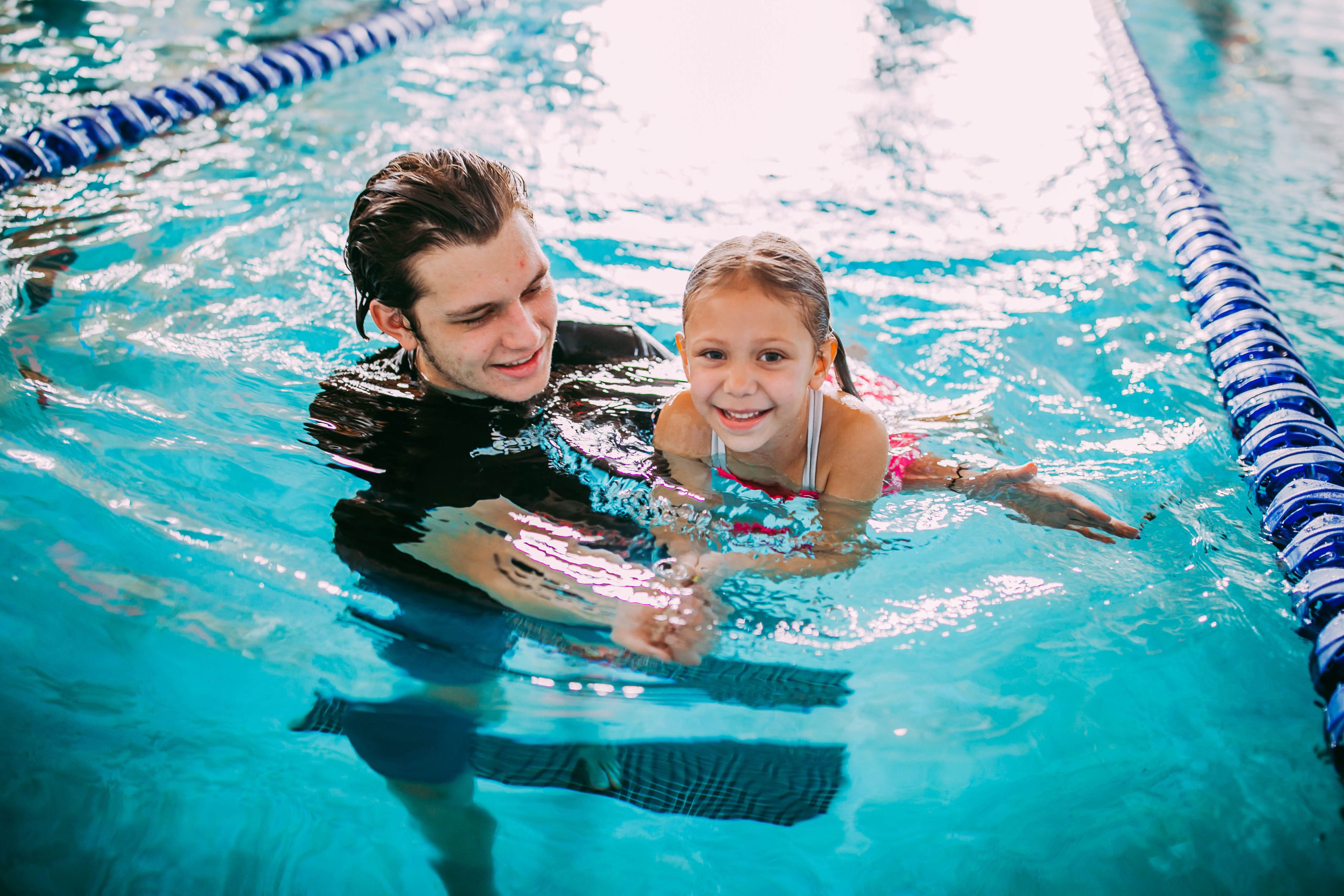 swim teach and student doing back float