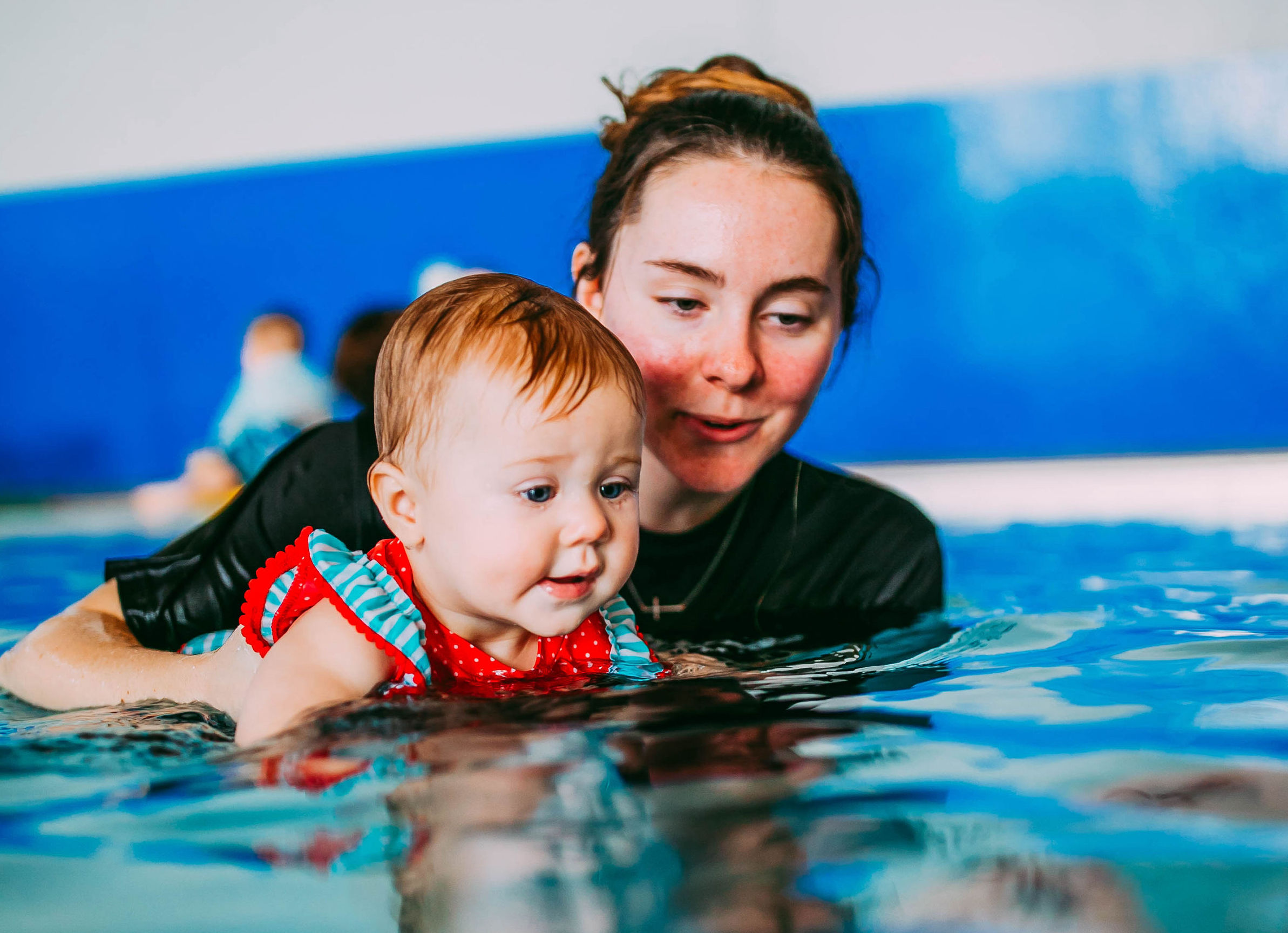 swim teach and student doing back float