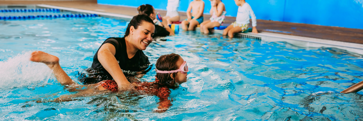 swim student and teacher swim kids kick splashing